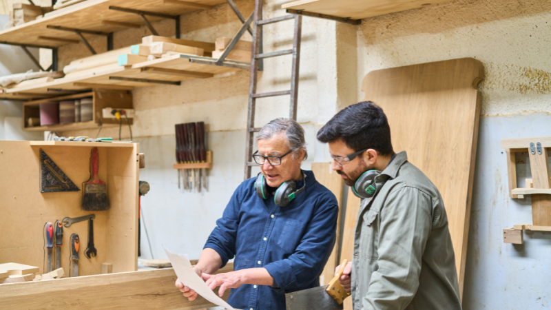 Carpentry apprentice learning from a supervisor