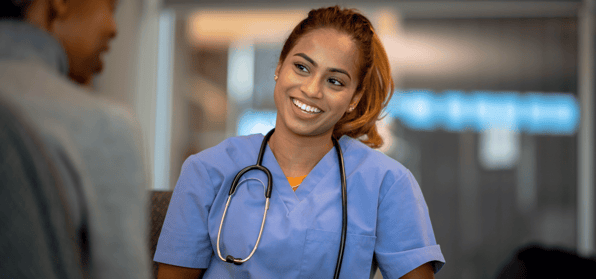 Young nurse looking towards a patient