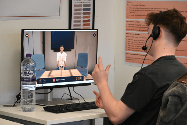 Male student sitting in front of a desktop computer using Bodyswaps