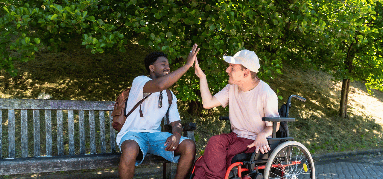 Two young men high-fiving.