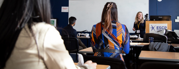 Female at sitting at desks in a lecture hall