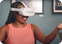 Lady in VR headset wearing a pink t-shirt