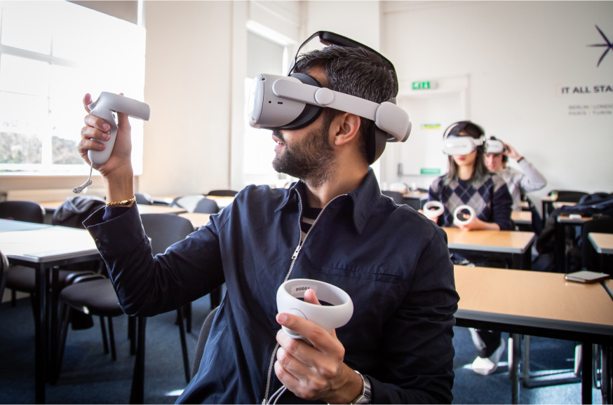 Man using a VR headset in a training classroom.