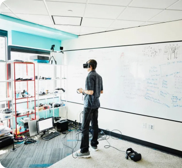 Stock image of boy in an office with a VR headset on