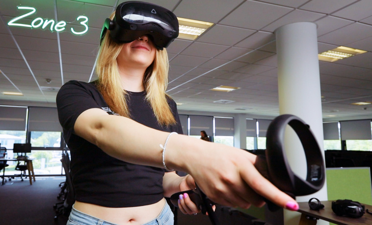 Teenage girl using VR in an office