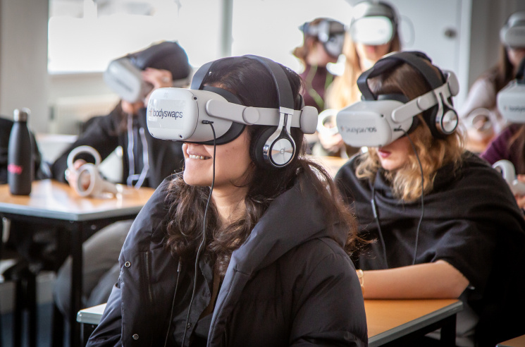 Students in a classroom wearing VR headsets.