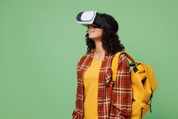 A young female student with a backpack, wearing a VR headset