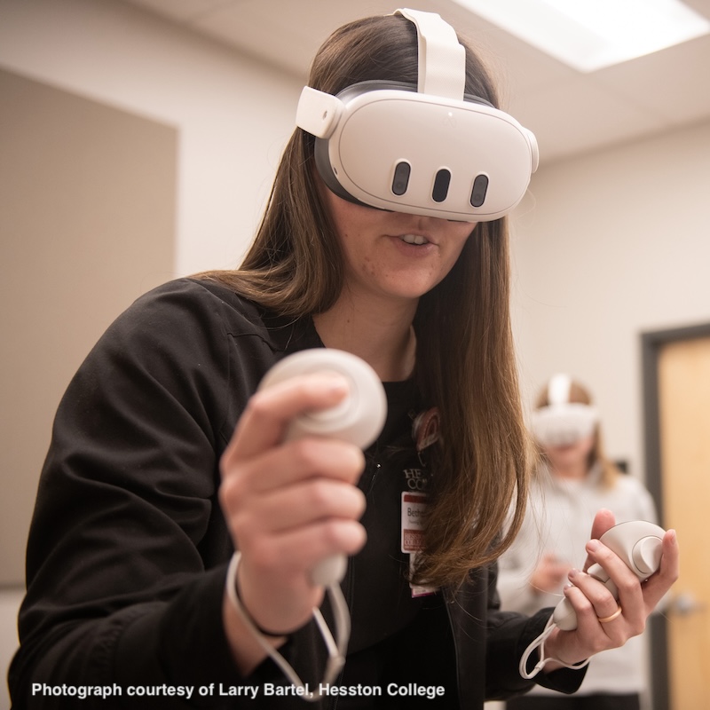 Female student using VR headset. Photograph courtesy of Larry Bartel, Hesston College
